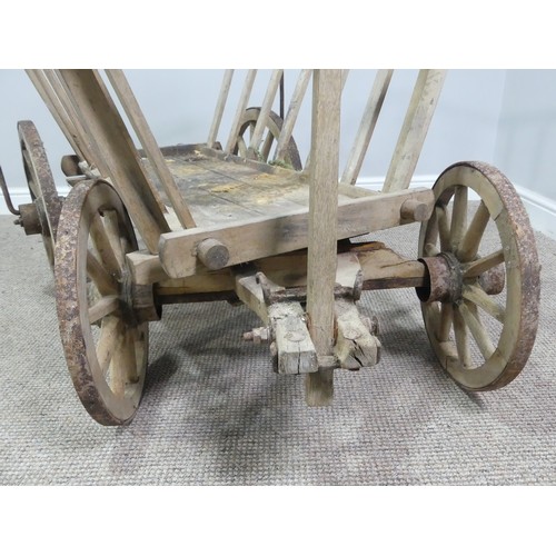 342 - A vintage four wheeled wooden dog/ log Cart, in weathered condition, W 120cm x D 62cm (wheel to whee... 