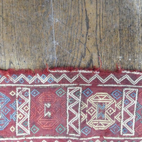 489 - Tribal Rugs; an Afghan rug, tekke on a red ground, 100% wool, fringes worn, 155cm x 183cm, together ... 