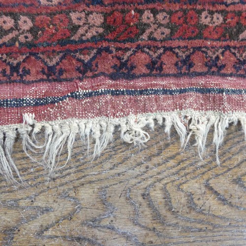 489 - Tribal Rugs; an Afghan rug, tekke on a red ground, 100% wool, fringes worn, 155cm x 183cm, together ... 