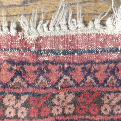 489 - Tribal Rugs; an Afghan rug, tekke on a red ground, 100% wool, fringes worn, 155cm x 183cm, together ... 