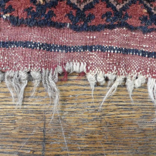 489 - Tribal Rugs; an Afghan rug, tekke on a red ground, 100% wool, fringes worn, 155cm x 183cm, together ... 