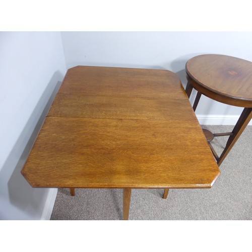 352 - An Edwardian oak Sutherland table, with canted corners to the rectangular top mounted on square legs... 