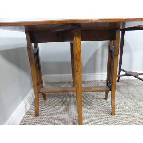 352 - An Edwardian oak Sutherland table, with canted corners to the rectangular top mounted on square legs... 