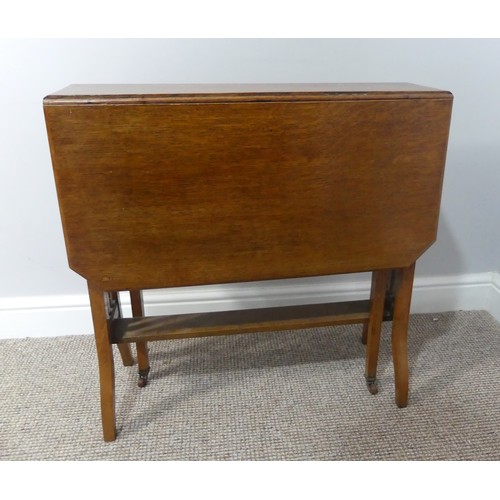 352 - An Edwardian oak Sutherland table, with canted corners to the rectangular top mounted on square legs... 