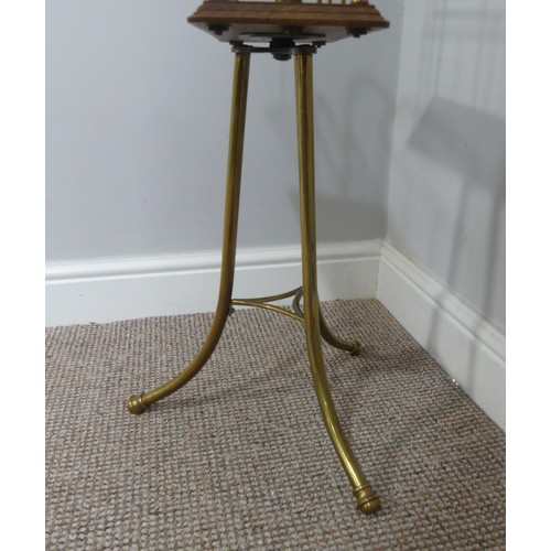 353 - An early 20th century brass and oak Magazine Stand, W 37cm x H 79cm x D 37cm.