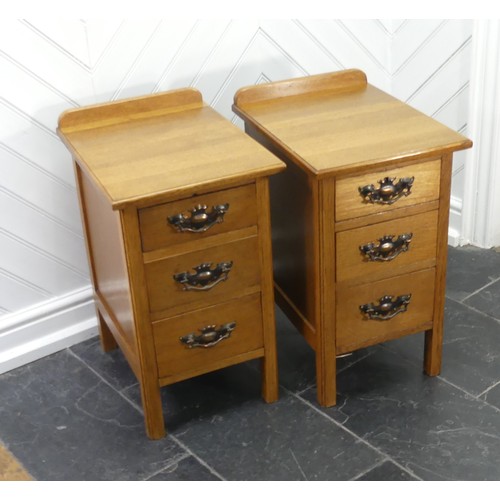 391 - A pair of Arts & Crafts light oak three-drawer Bedside Cabinets, fitted with later embossed bras... 