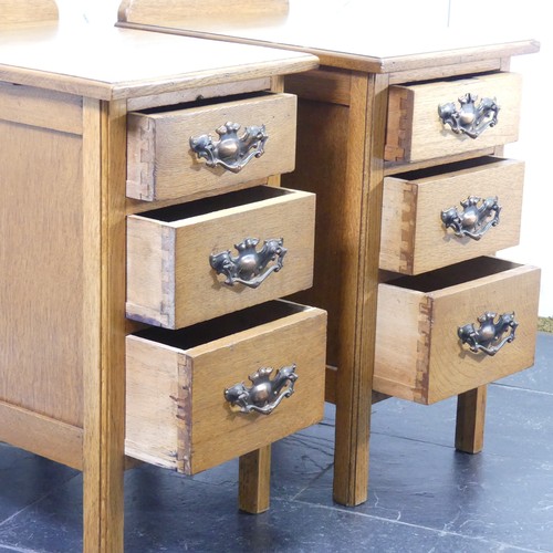 391 - A pair of Arts & Crafts light oak three-drawer Bedside Cabinets, fitted with later embossed bras... 