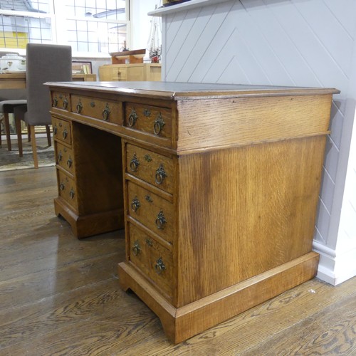 395 - An early 20thC Gothic style oak Pedestal Desk, the rectangular top with tooled leather writing inset... 