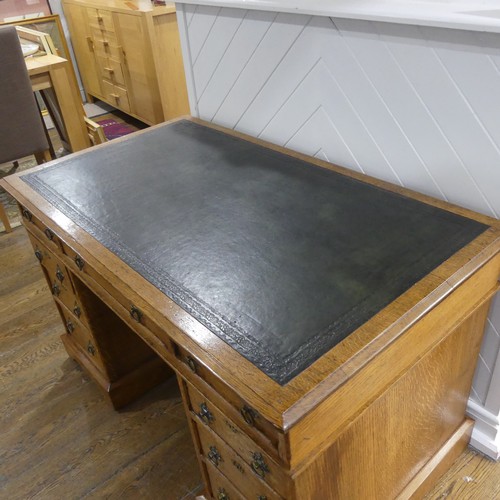 395 - An early 20thC Gothic style oak Pedestal Desk, the rectangular top with tooled leather writing inset... 