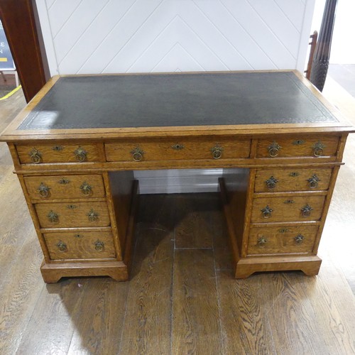 395 - An early 20thC Gothic style oak Pedestal Desk, the rectangular top with tooled leather writing inset... 