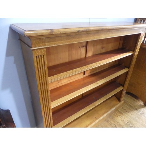 396 - An Edwardian light oak open Bookcase, with three adjustable shelves flanked by pilasters on plinth b... 