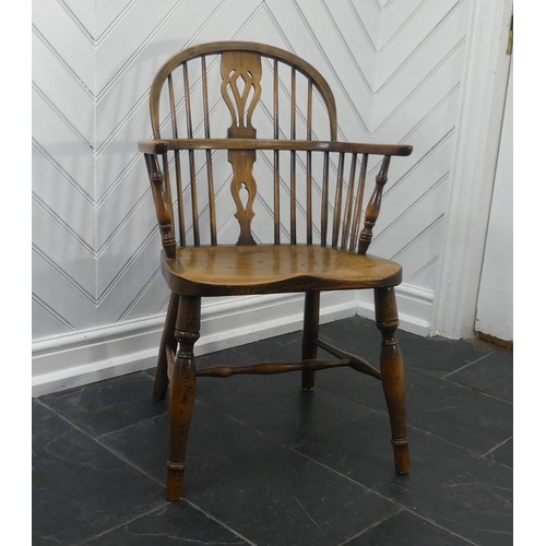 434 - A Late 19thC antique style ash and elm Windsor Chair, with pierced splat back, solid seat raised on ... 