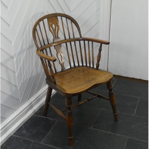 434 - A Late 19thC antique style ash and elm Windsor Chair, with pierced splat back, solid seat raised on ... 