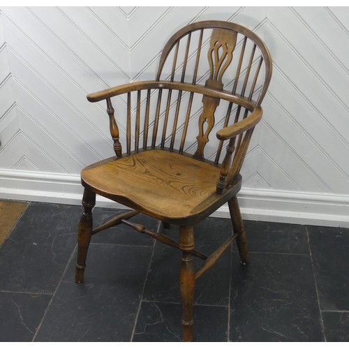 434 - A Late 19thC antique style ash and elm Windsor Chair, with pierced splat back, solid seat raised on ... 