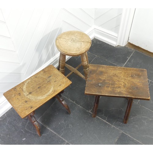 435 - An antique rustic Milking Stool, the rectangular top raised on four round legs supported by two stre... 