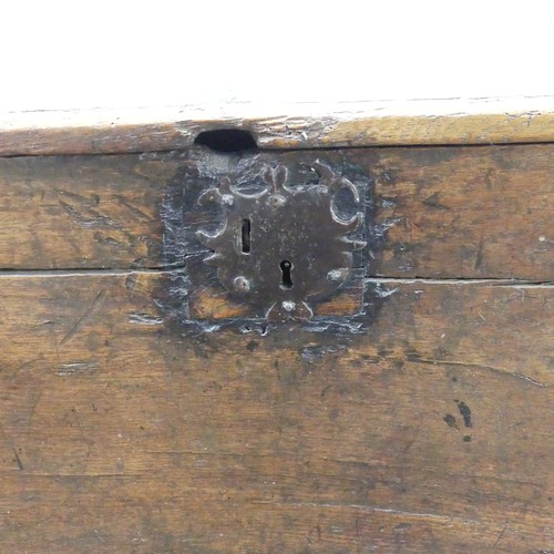 438 - An antique oak Coffer, of small size raised on stile feet, the interior with candlebox, with alterat... 