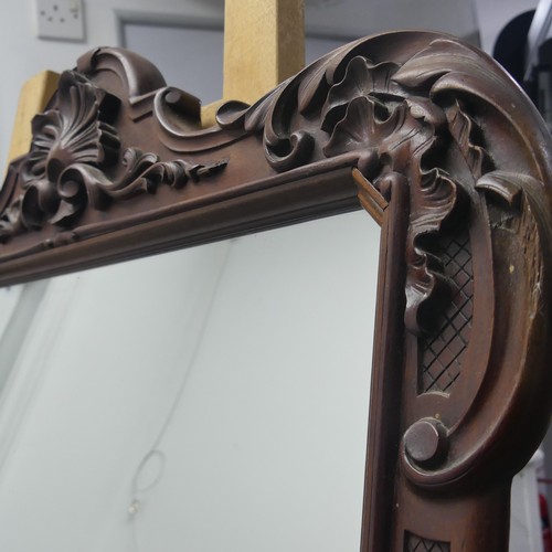 443 - A decorative wall mirror with carved hardwood frame (formally a fire screen), W 64cm x H 96cm.... 