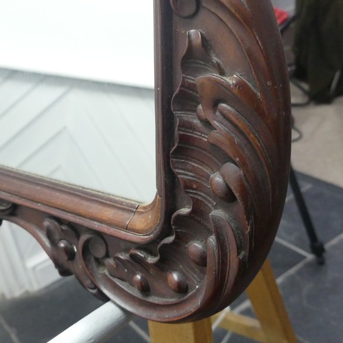 443 - A decorative wall mirror with carved hardwood frame (formally a fire screen), W 64cm x H 96cm.... 