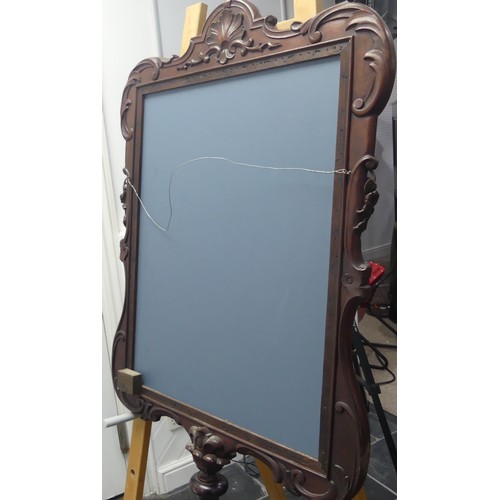 443 - A decorative wall mirror with carved hardwood frame (formally a fire screen), W 64cm x H 96cm.... 