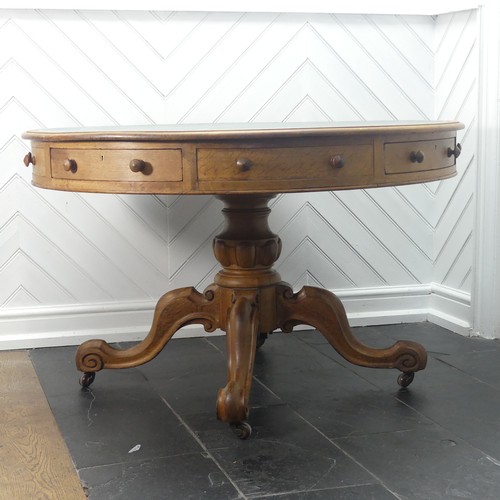 450 - A early 20thC Victorian oak Drum Table, the circular top with a tooled leather writing surface over ... 