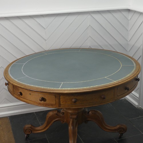 450 - A early 20thC Victorian oak Drum Table, the circular top with a tooled leather writing surface over ... 