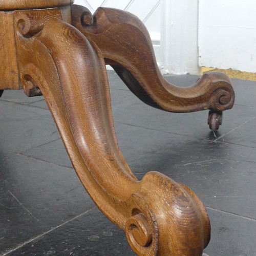 450 - A early 20thC Victorian oak Drum Table, the circular top with a tooled leather writing surface over ... 