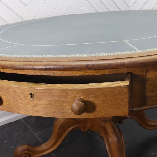 450 - A early 20thC Victorian oak Drum Table, the circular top with a tooled leather writing surface over ... 