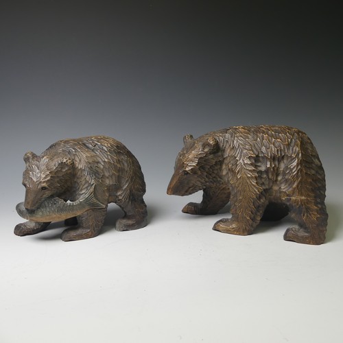 458 - A small Black Forest style strolling Bear, carrying a salmon, 17cm long, together with a larger bear... 