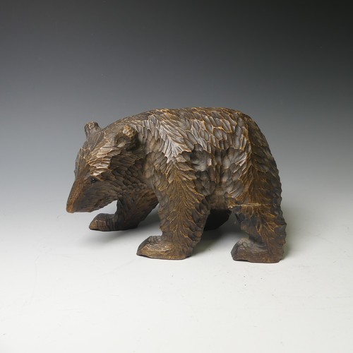 458 - A small Black Forest style strolling Bear, carrying a salmon, 17cm long, together with a larger bear... 