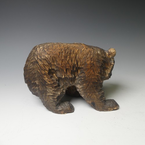 458 - A small Black Forest style strolling Bear, carrying a salmon, 17cm long, together with a larger bear... 