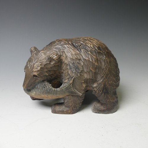 458 - A small Black Forest style strolling Bear, carrying a salmon, 17cm long, together with a larger bear... 