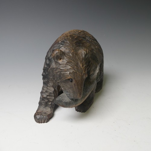 458 - A small Black Forest style strolling Bear, carrying a salmon, 17cm long, together with a larger bear... 