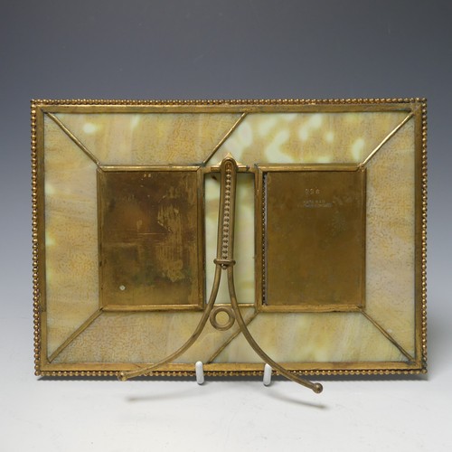 459 - Tiffany Studios; a gilt bronze twin photograph Frame, in the 'pine needle' pattern with favrile glas... 