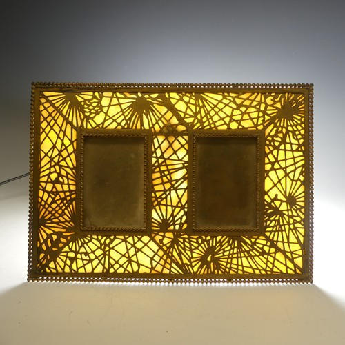 459 - Tiffany Studios; a gilt bronze twin photograph Frame, in the 'pine needle' pattern with favrile glas... 