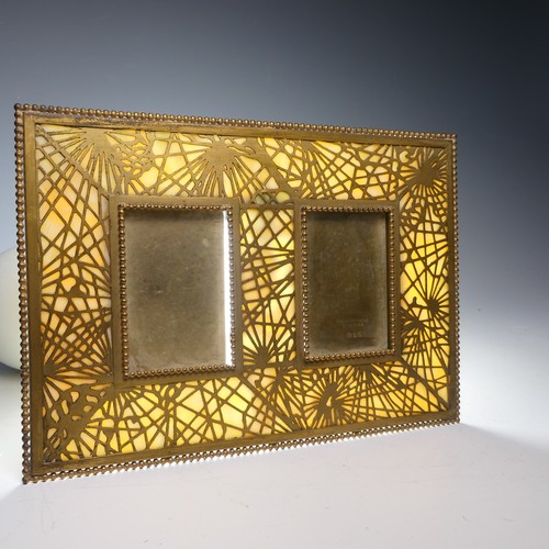 459 - Tiffany Studios; a gilt bronze twin photograph Frame, in the 'pine needle' pattern with favrile glas... 