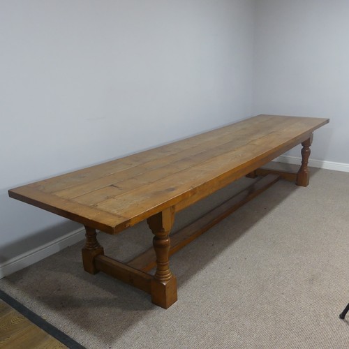 An Early 20thC oak refectory Dining Table, large rectangular four plank top with cleated ends, supported by bulbous legs supported 'H' stretcher, W 367.5cm H 75.5cm D 92cm.