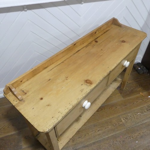 375 - An early 20thC pine Dresser Base, with two draws, W 137.5cm x H 92cm x D 42cm.