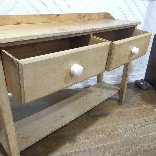 375 - An early 20thC pine Dresser Base, with two draws, W 137.5cm x H 92cm x D 42cm.