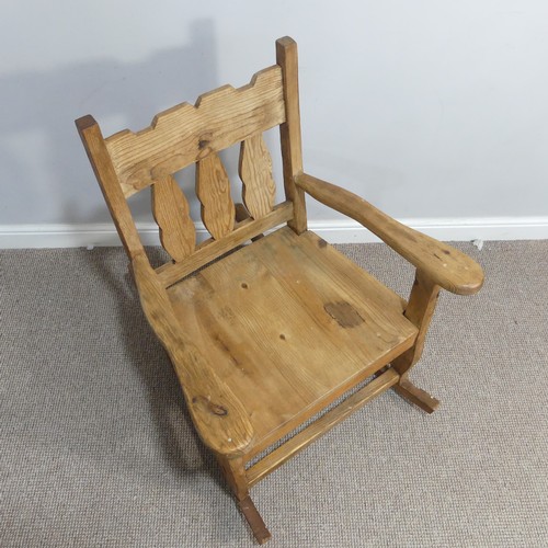 381 - A 20thC carved pine Rocking Chair, W 69cm x H 92.5cm x D 92cm.