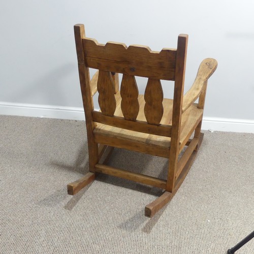 381 - A 20thC carved pine Rocking Chair, W 69cm x H 92.5cm x D 92cm.