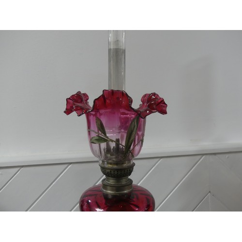 301 - A Victorian brass column Duplex Oil Lamp, having a painted opaque pink font and Duplex burner, raise... 