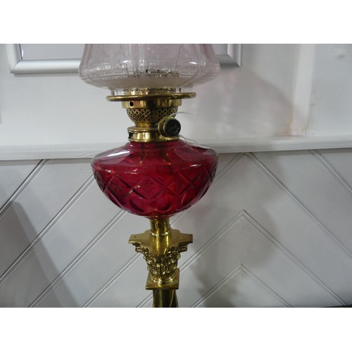 304 - A Victorian Hinks patent brass column Oil Lamp, having a cut cranberry glass font and clear and cran... 