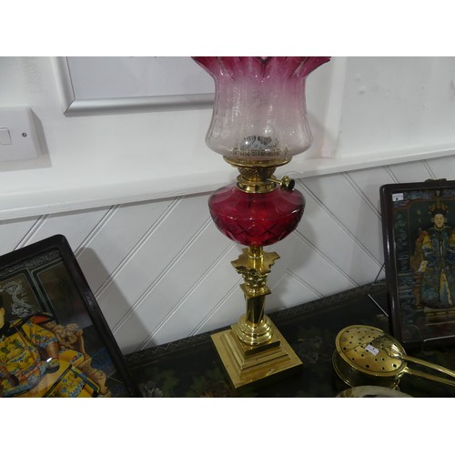 304 - A Victorian Hinks patent brass column Oil Lamp, having a cut cranberry glass font and clear and cran... 