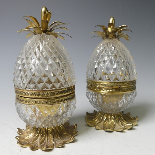 34 - A pair of French glass and gilt metal pineapple form Boxes, on a multi-leaf domed base and topped wi... 