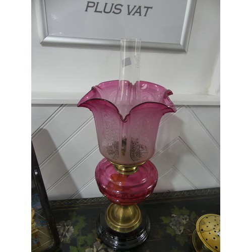 A Victorian Brass And Cut Glass Oil Lamp Having A Cut Cranberry Glass Font And Etched Glass Shade