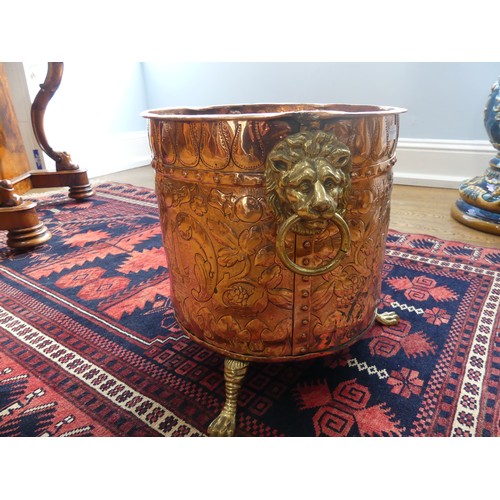 308 - An early 20thC ornate copper and brass Coal Bucket, having embossed and etched decoration of an armo... 