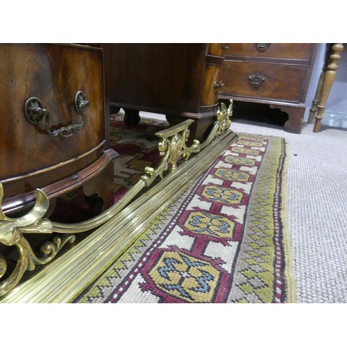 320 - A brass fire fender with ornate gallery, 133cmL x 36cmD x17H.