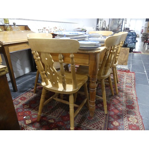 407 - A pine kitchen Table with six Chairs, only one frieze drawer present, W 136cm x H 77cm x D 76cm (tab... 