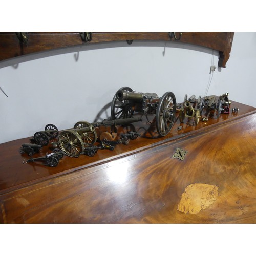 408 - A decorative cannon together with approx twenty more decorative smaller cannons, W18.5cm x H 18cm x ... 