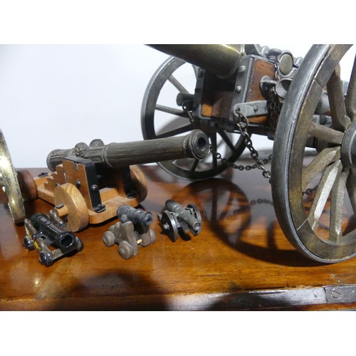 408 - A decorative cannon together with approx twenty more decorative smaller cannons, W18.5cm x H 18cm x ... 